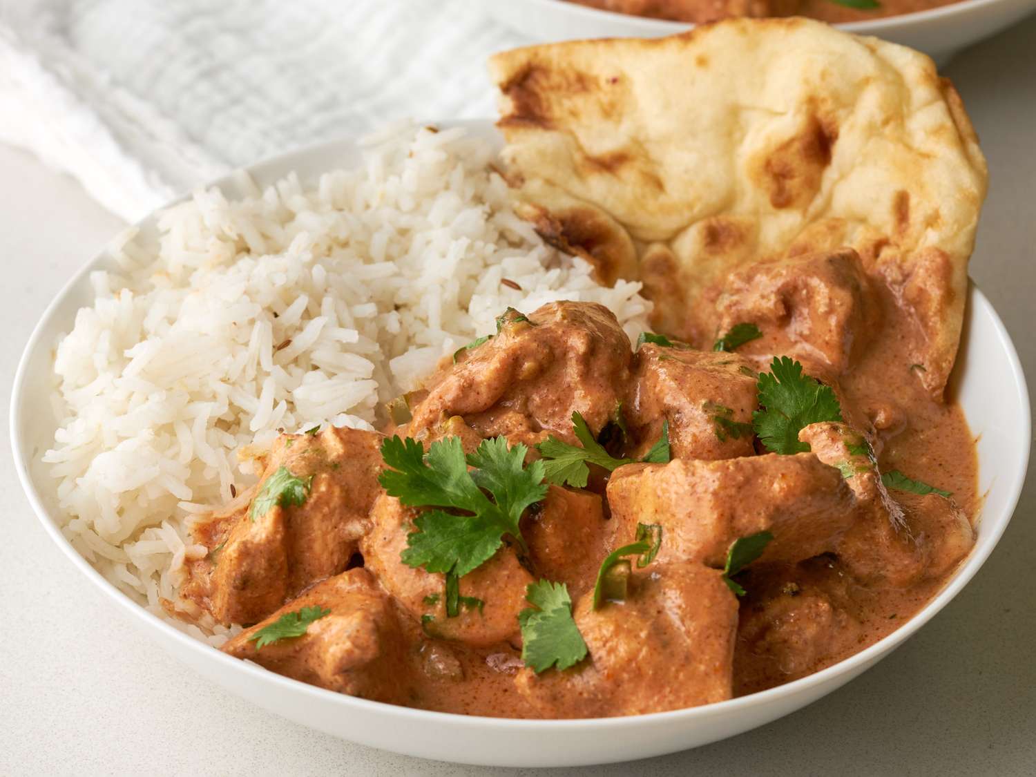 Pollo Tikka Masala tradicional indio con salsa cremosa especiada
